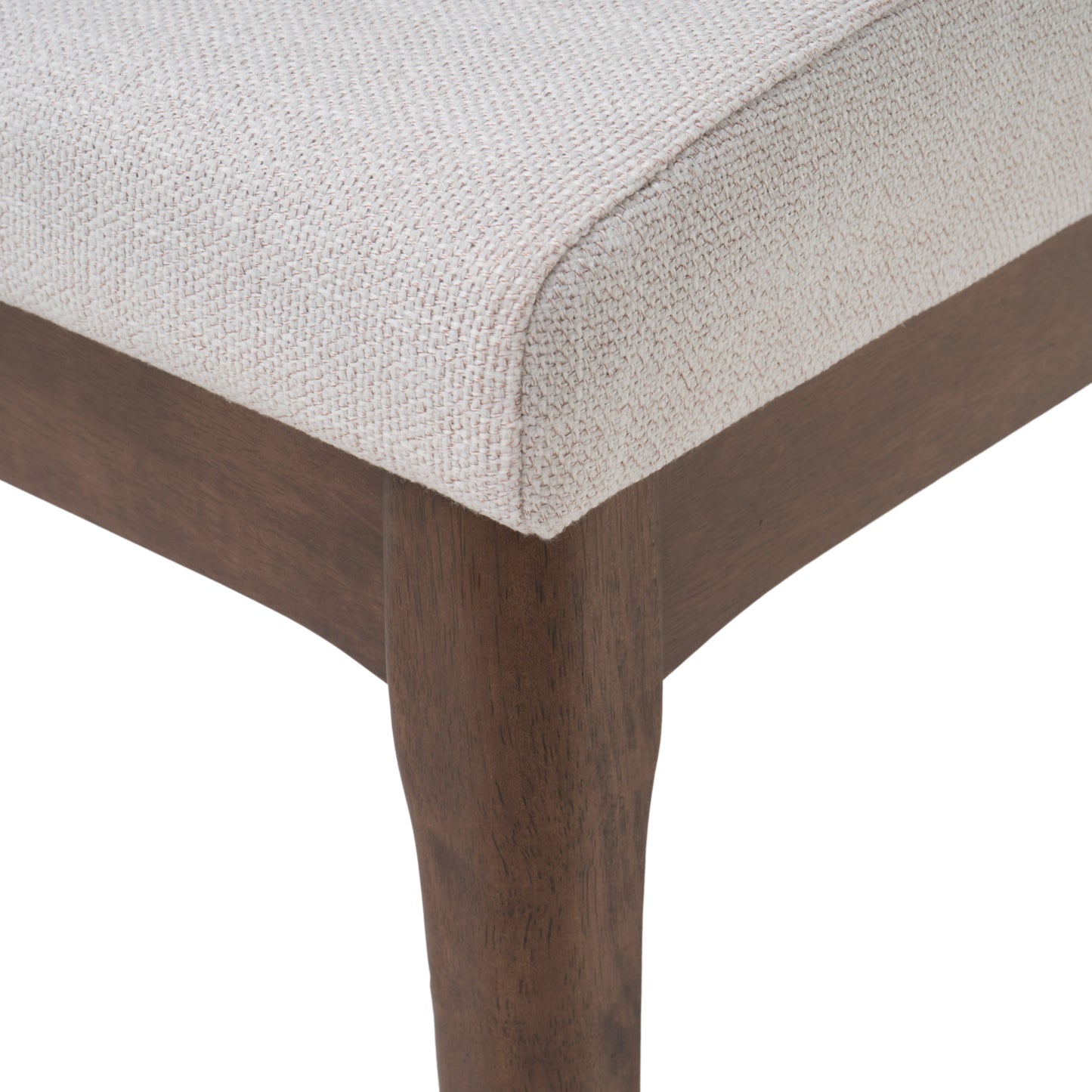 Closeup of textured beige fabric seat cushion and dark wood frame chair leg