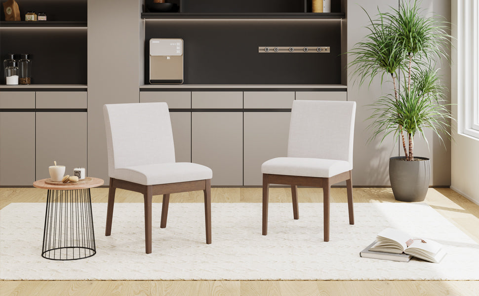 Two white upholstered dining chairs with wooden legs