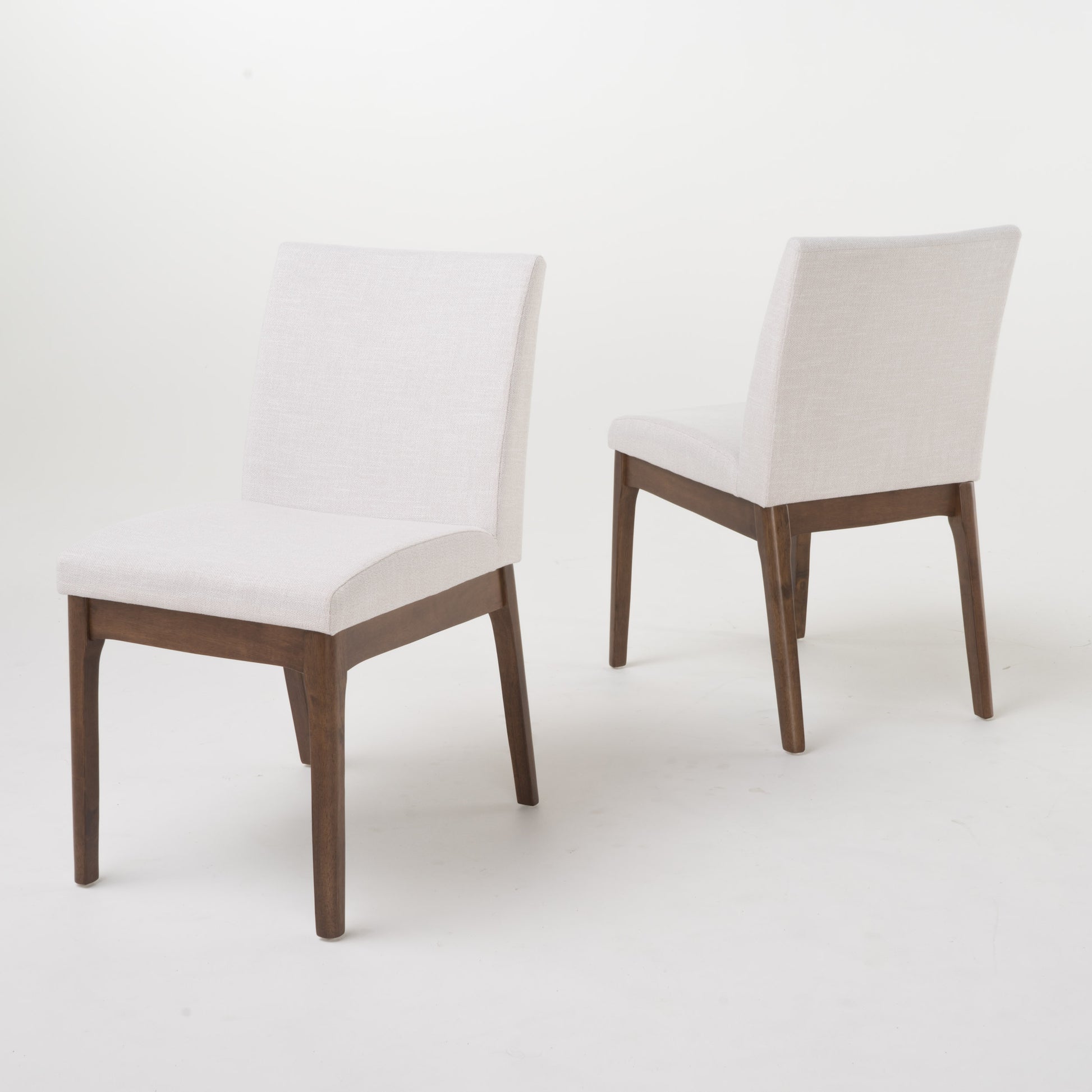 Modern dining chair with white linen upholstery and dark wood legs