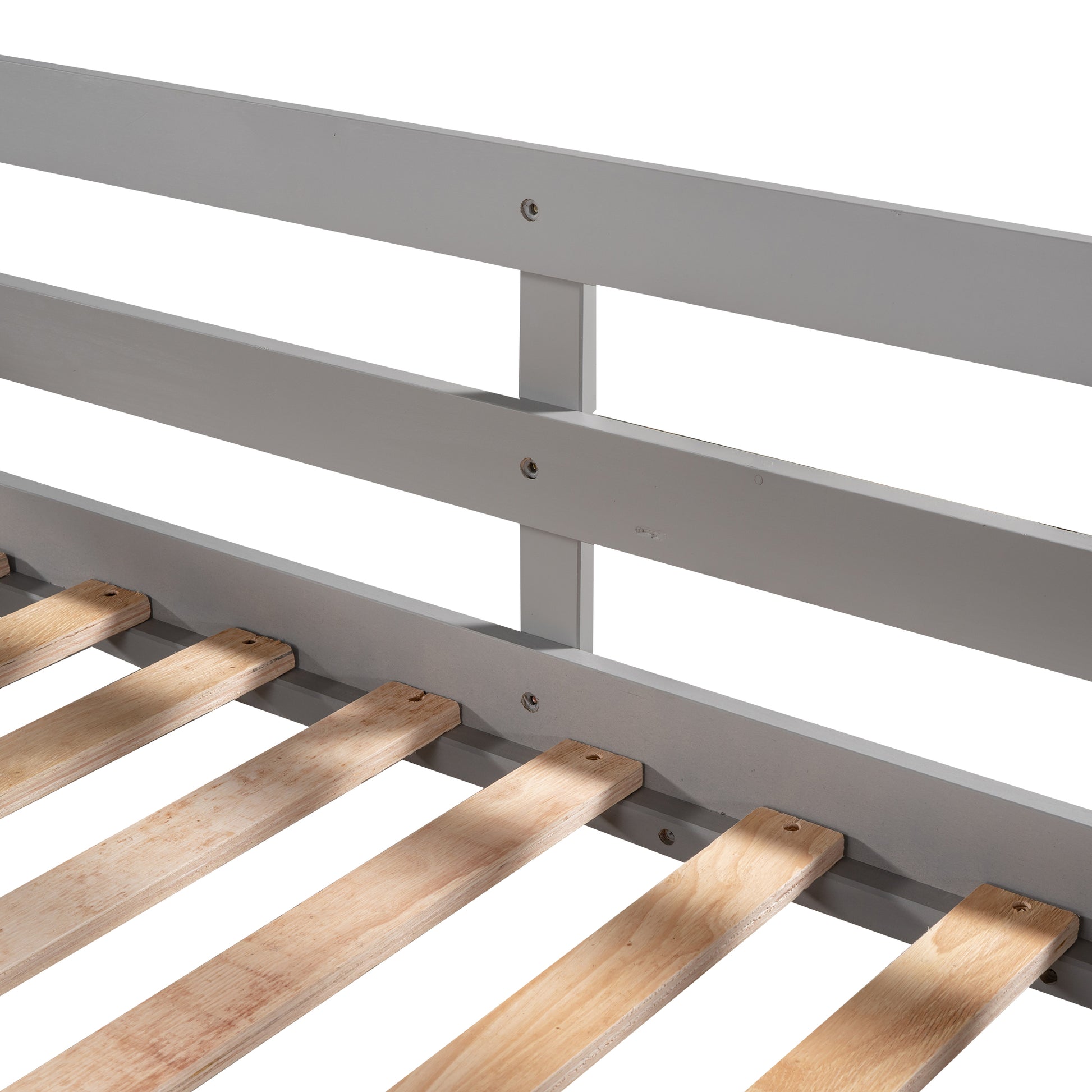 Closeup of grey wooden bed frame with pine slats