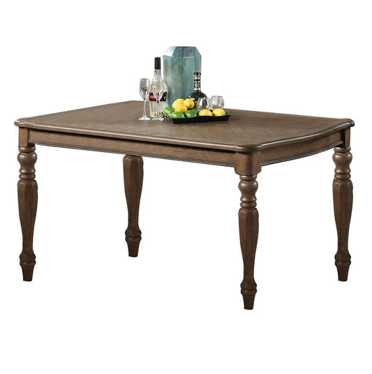 Wooden dining table with carved legs and decorative fruit centerpiece