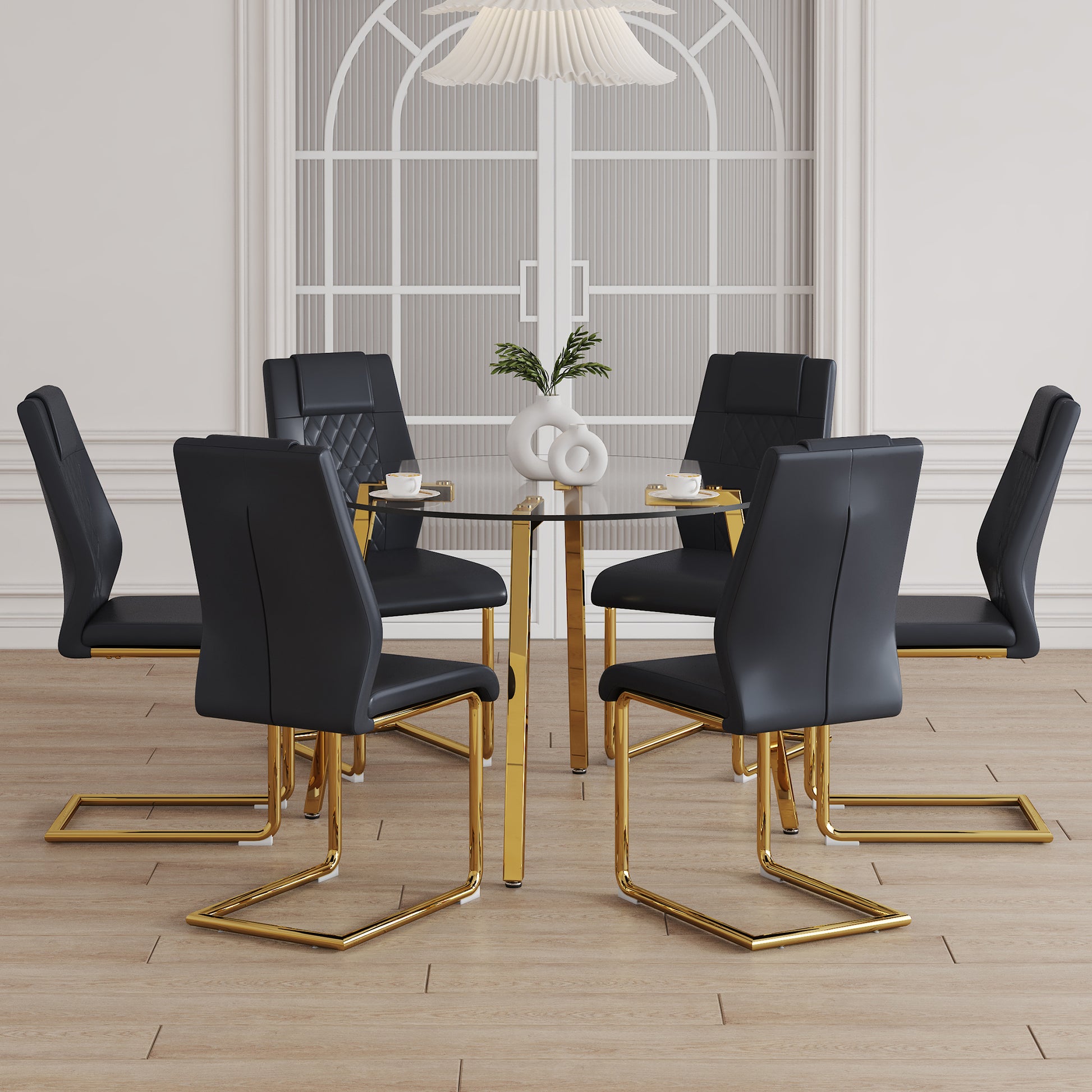 Black upholstered dining chairs with quilted backs and gold sled legs