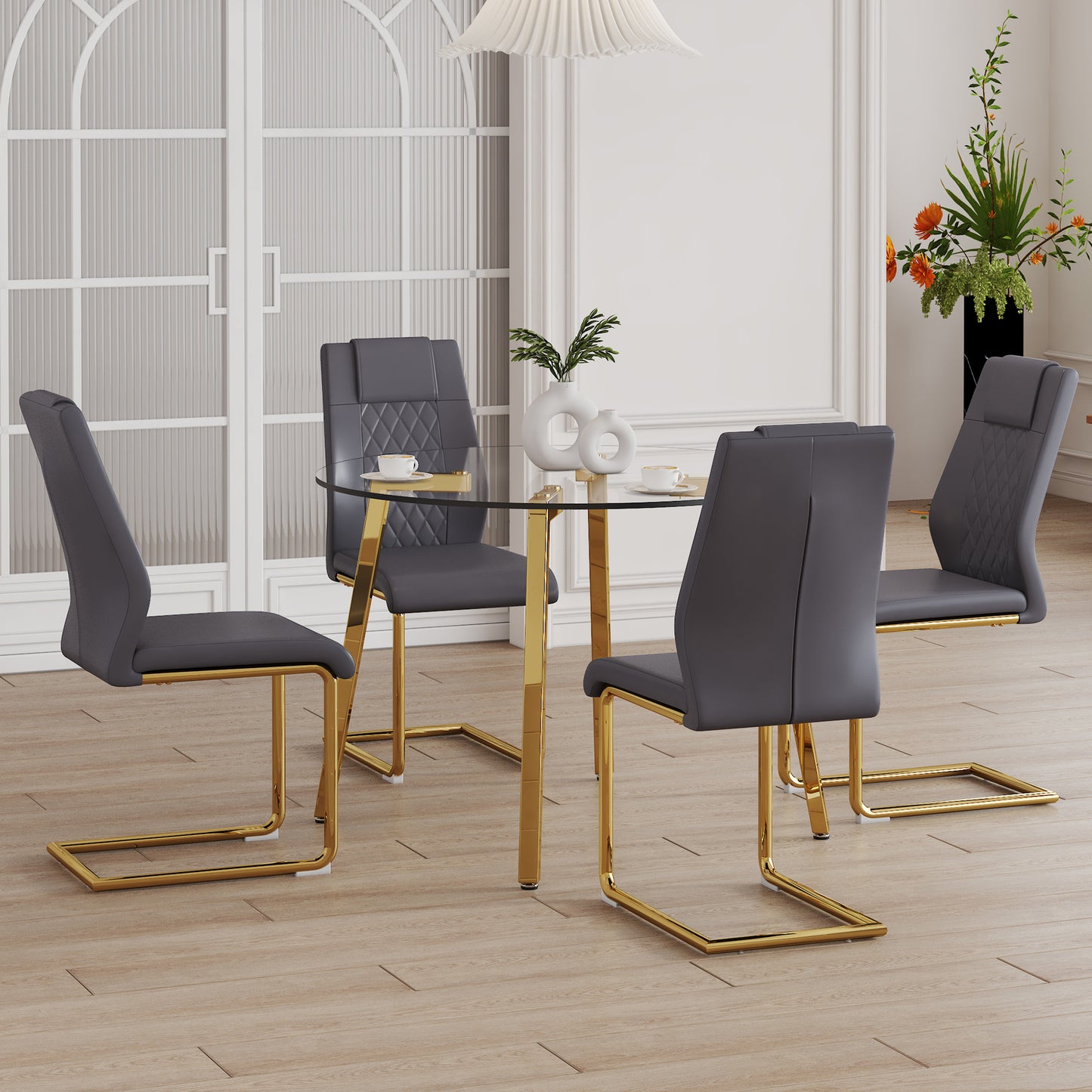 Dark grey dining chairs with diamondstitched backrests around a glasstop dining table