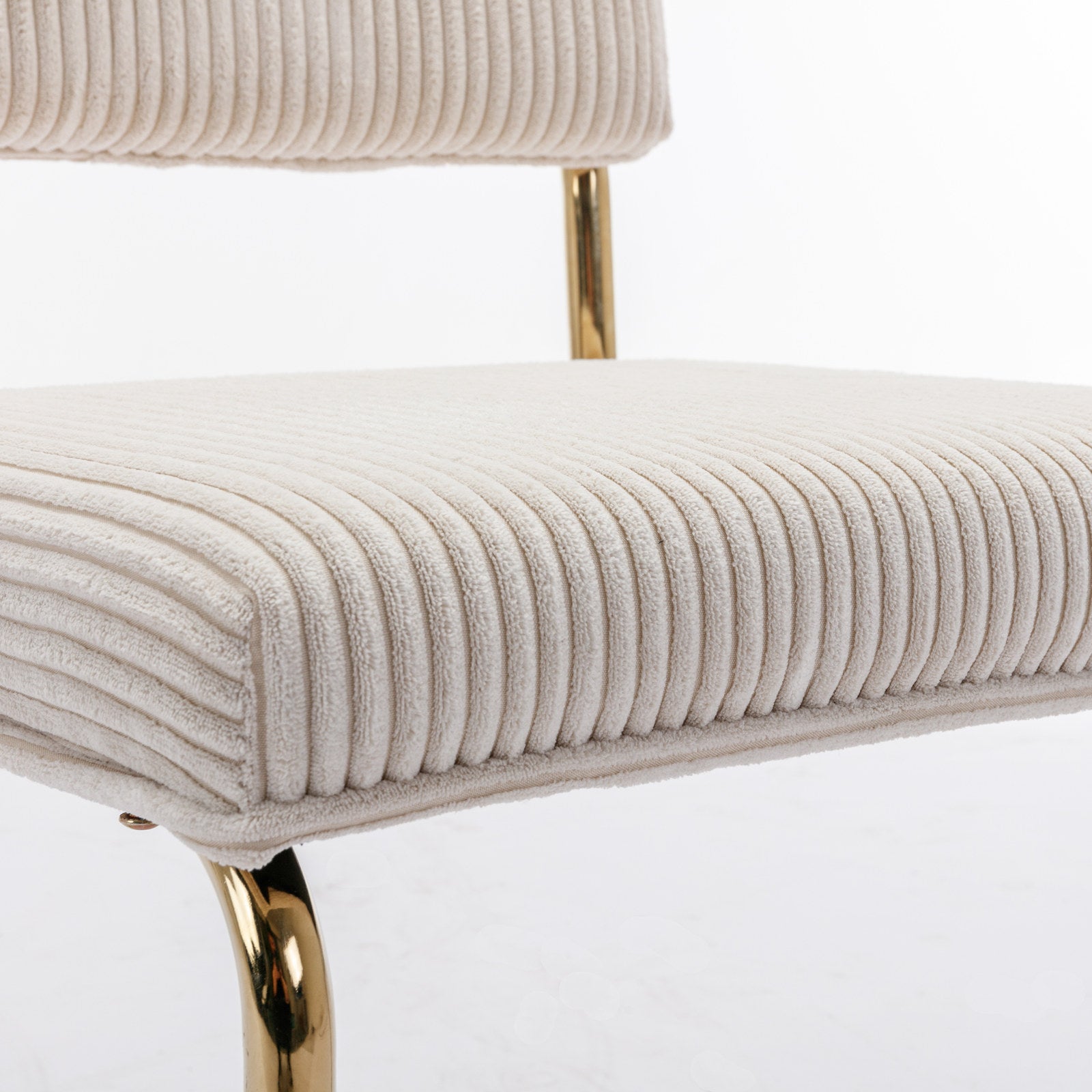 Cream corduroy accent chair with plush seat and gold metal legs