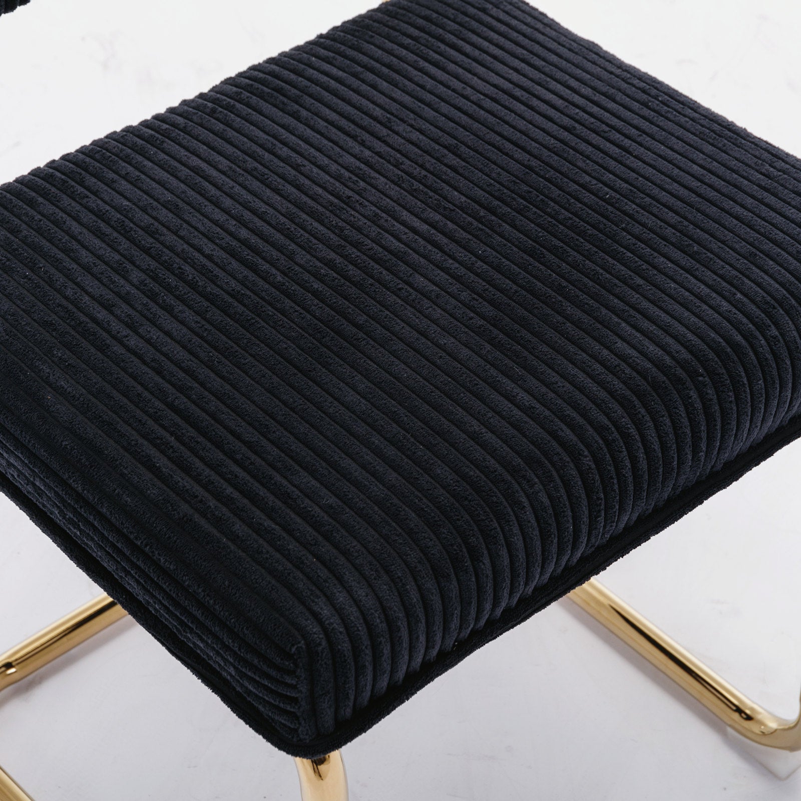 Black corduroy accent chair with gold metal legs