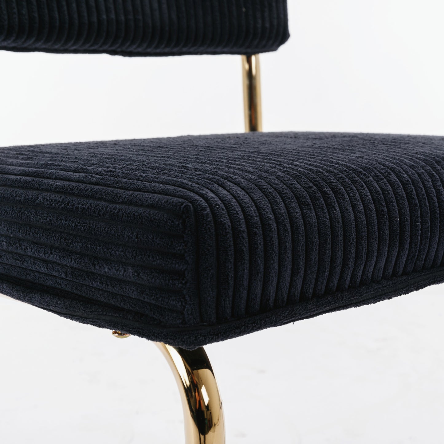 Black corduroy accent chair seat with plush texture and gold metal legs
