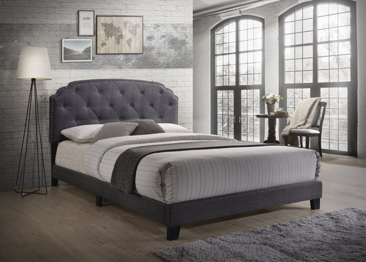 Dark grey fabric upholstered bed frame with tufted headboard and studded trim