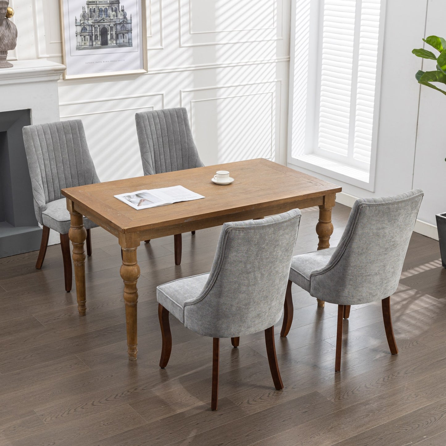 Set of  gray upholstered dining chairs around a rustic wooden table