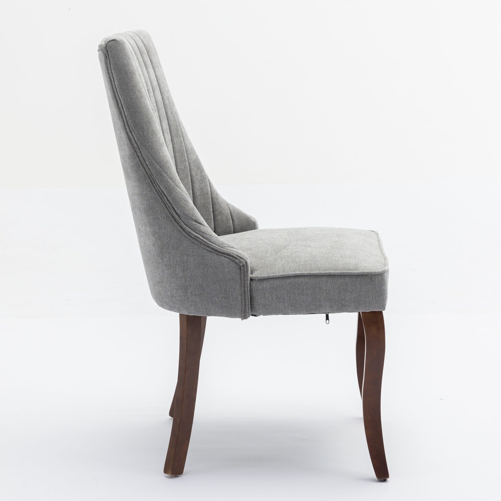 Grey upholstered dining chair with button tufting and wooden legs