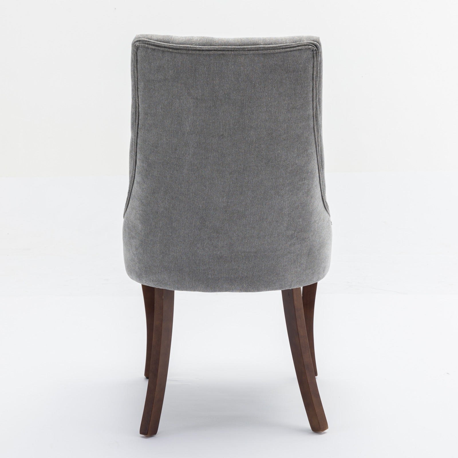 Grey upholstered dining chair with dark wood legs