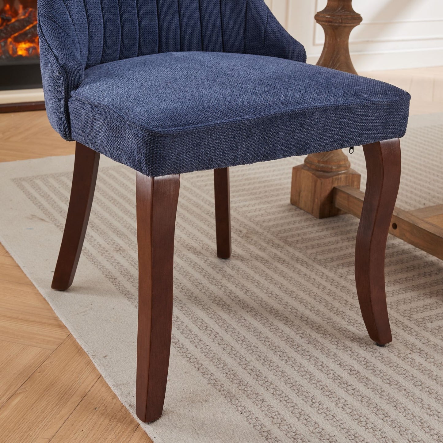 Blue upholstered dining chair with tufted back and dark wood legs