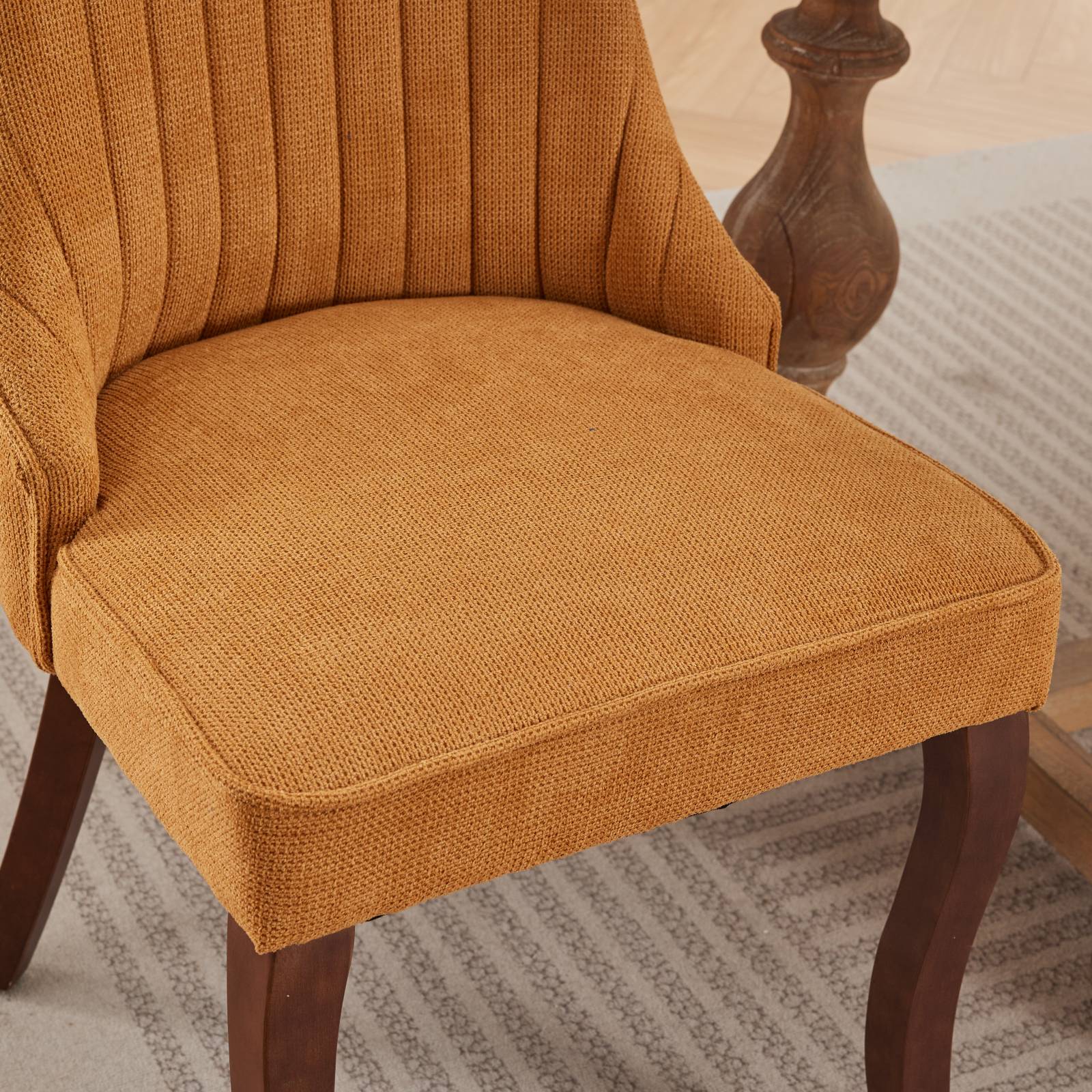 Orange upholstered dining chair with channel tufted back