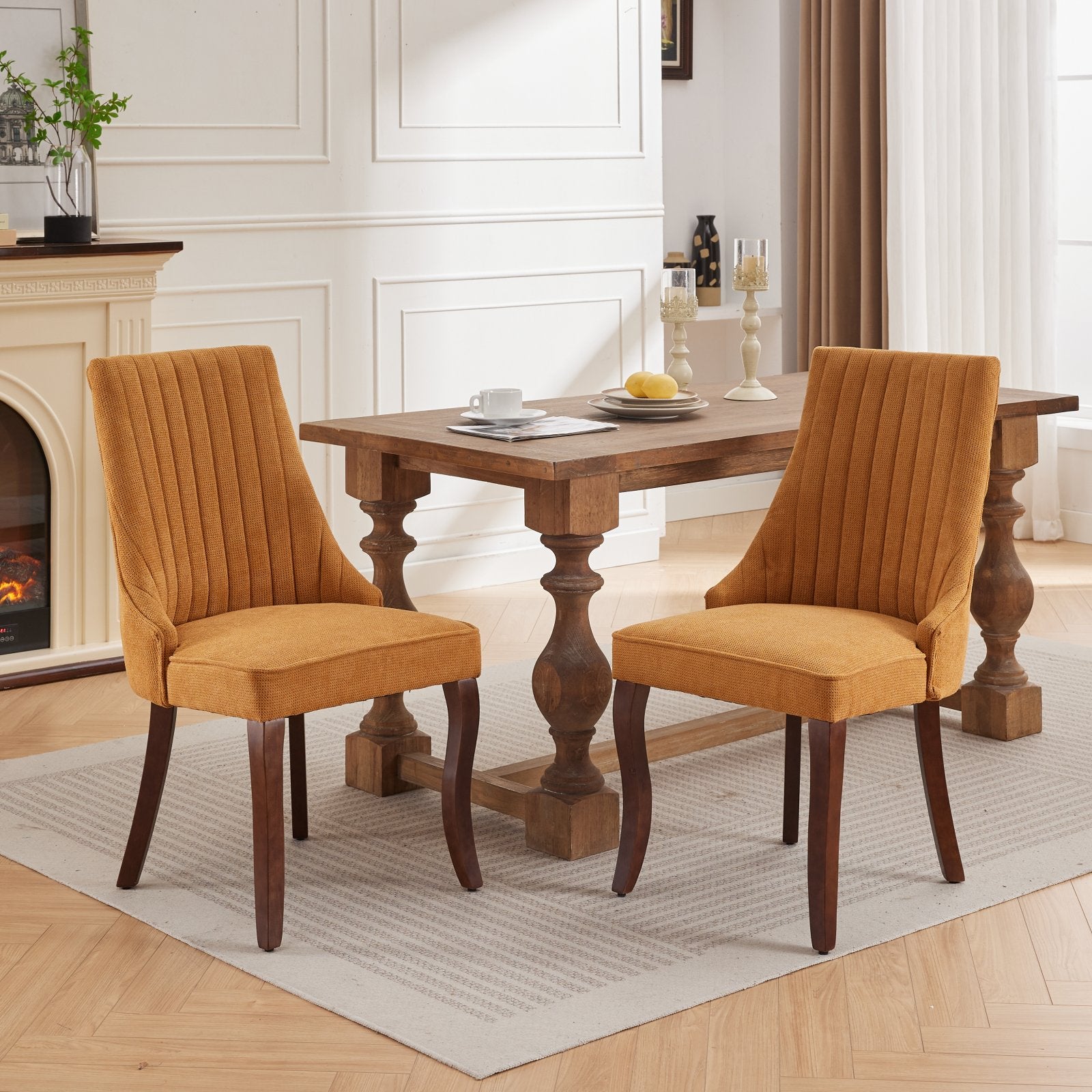 Two textured mustard yellow dining chairs with channel tufting and dark wooden legs arranged around a rustic farmhouse table