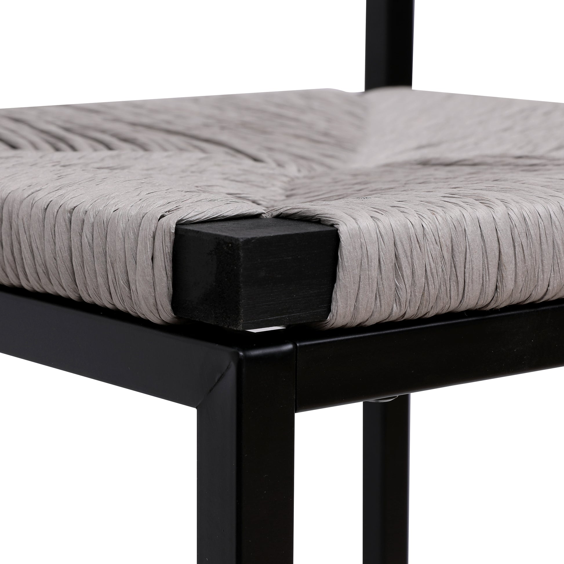 Closeup of woven grey raffia seat on a black metal stool