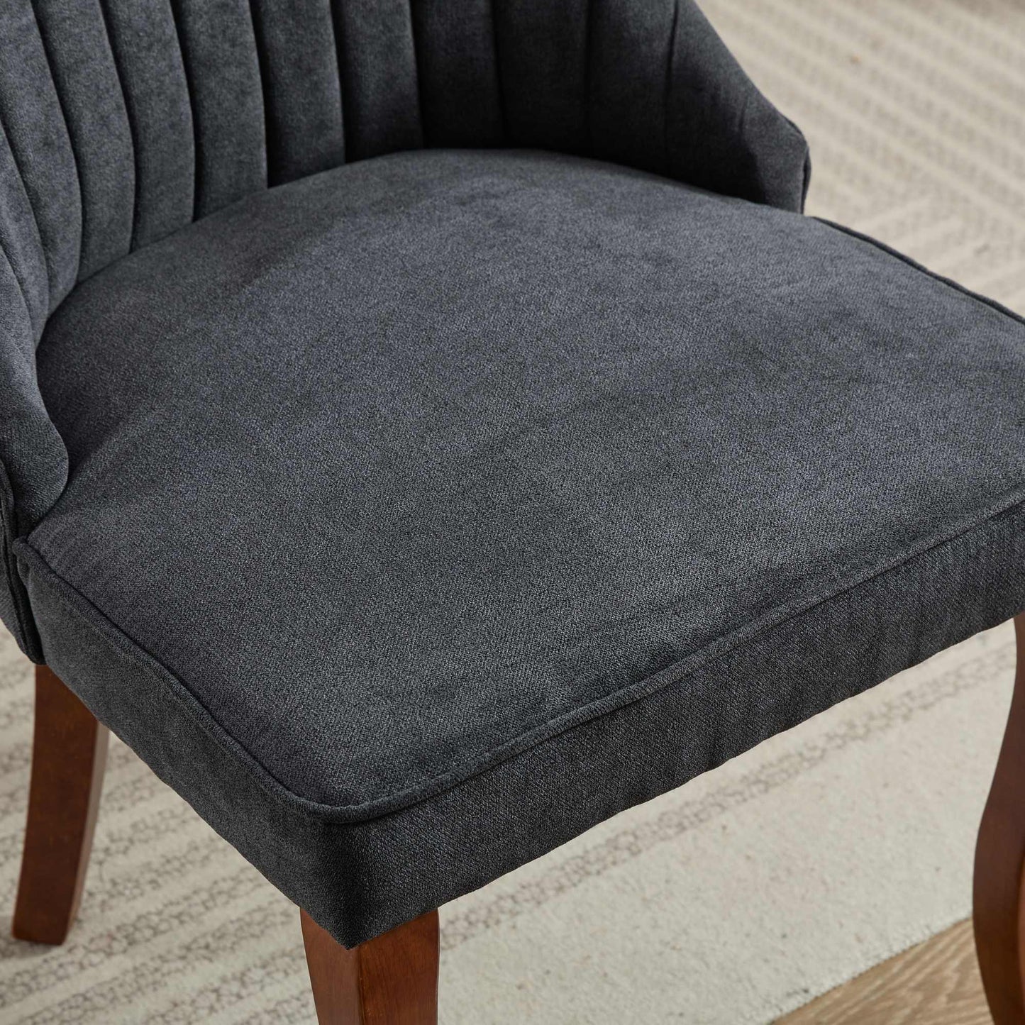 Dark gray upholstered chair seat with channeled back detail
