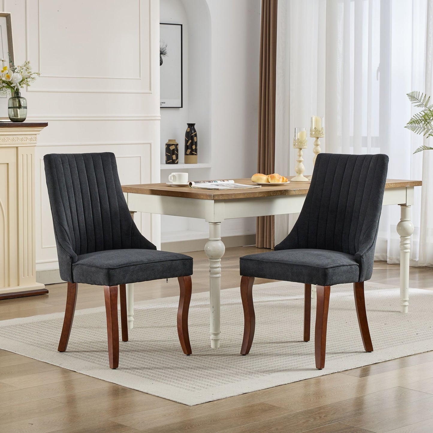 Dark gray upholstered dining chair with vertical channel tufting and wooden legs