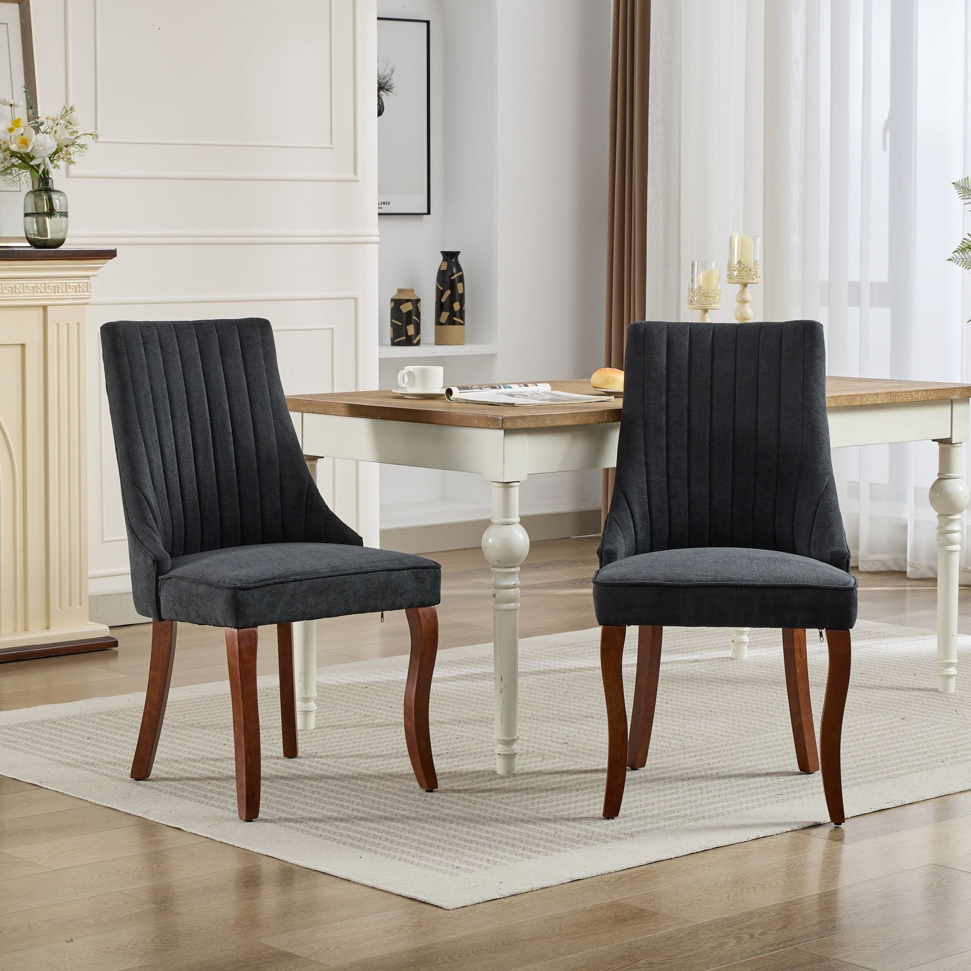 Dark gray upholstered dining chair with fluted back and wooden legs
