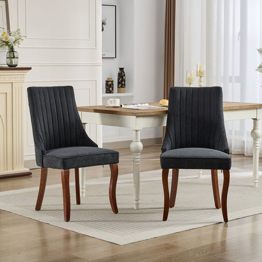Dark gray upholstered dining chair with fluted back and wooden legs