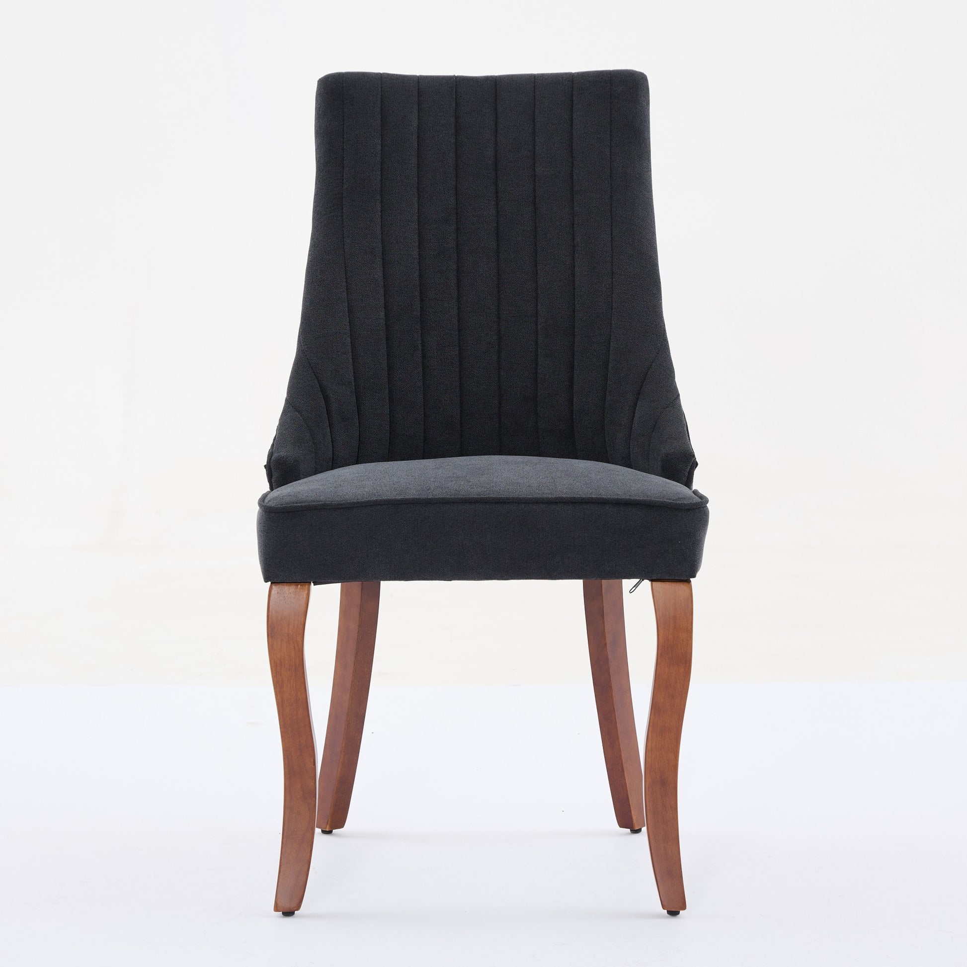 Dark gray upholstered dining chair with channeled back and wooden legs