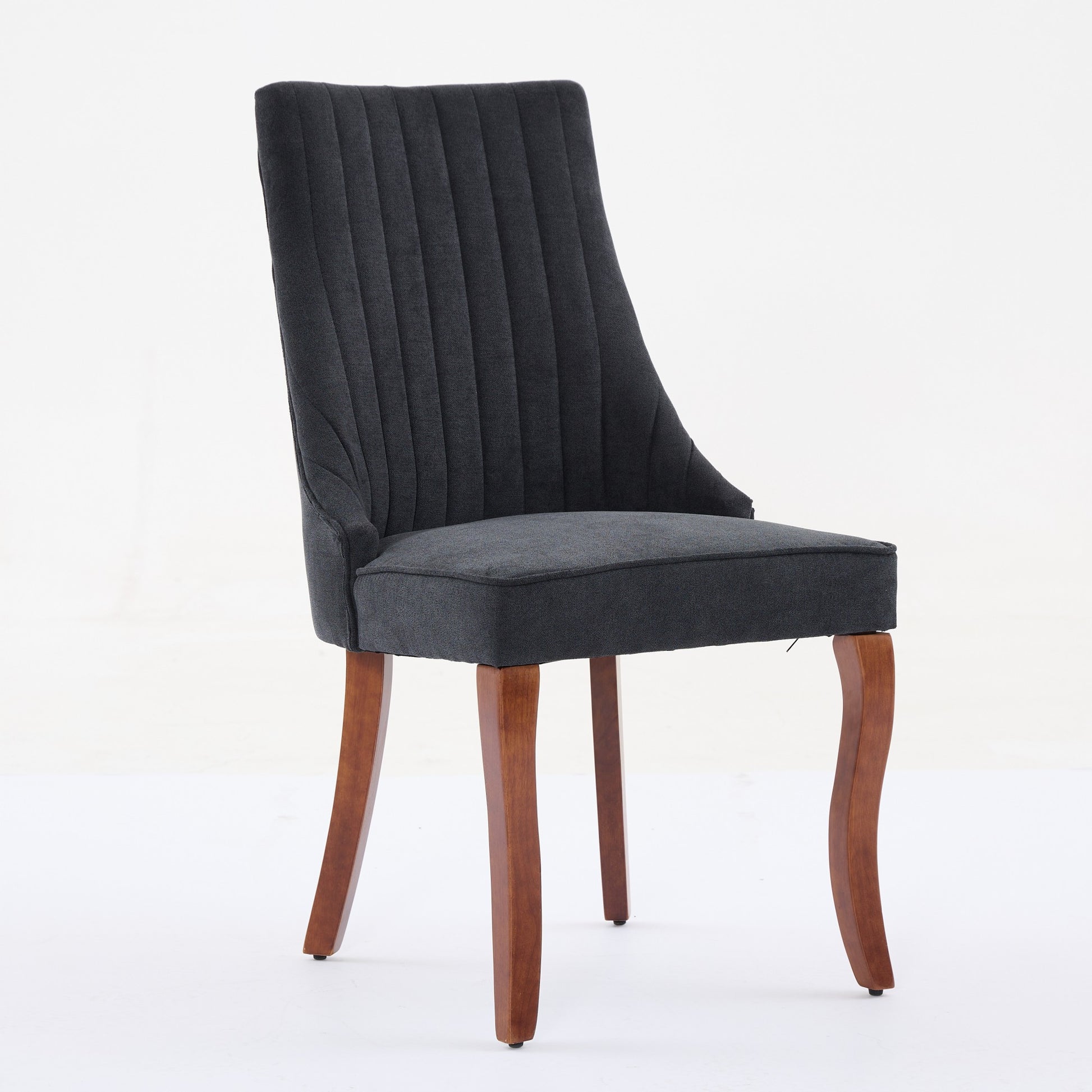 Dark gray upholstered dining chair with channel tufting and tapered wooden legs