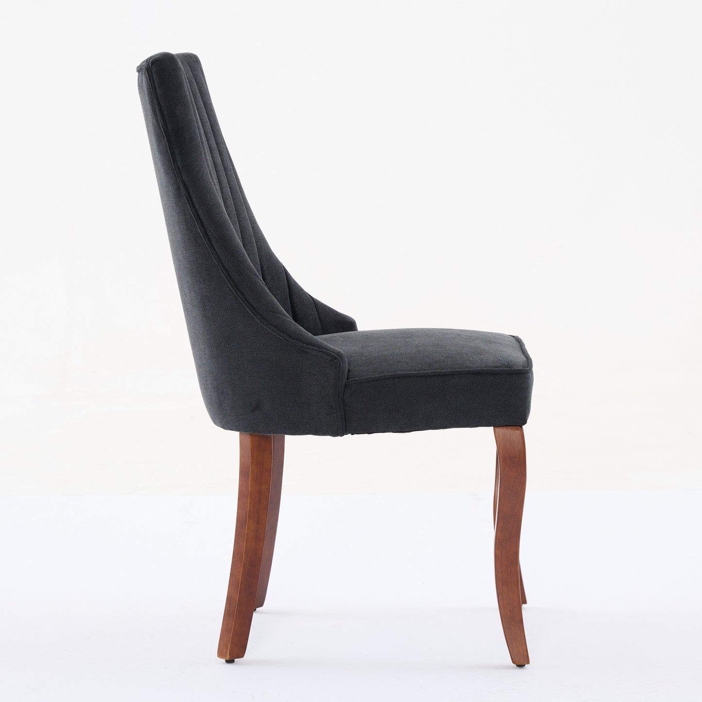 Dark grey upholstered dining chair with tufted back and wooden legs