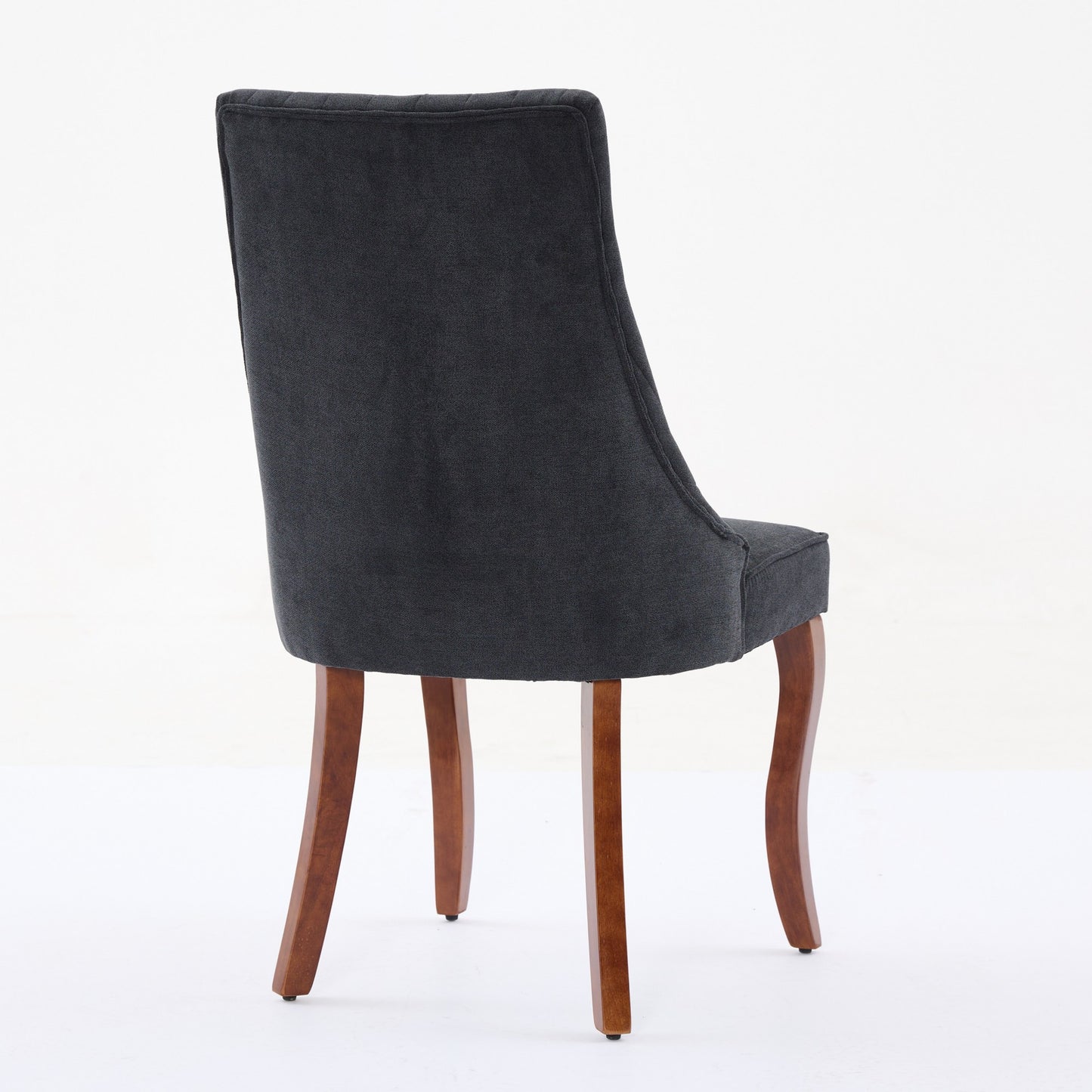Dark grey upholstered dining chair with curved wooden legs
