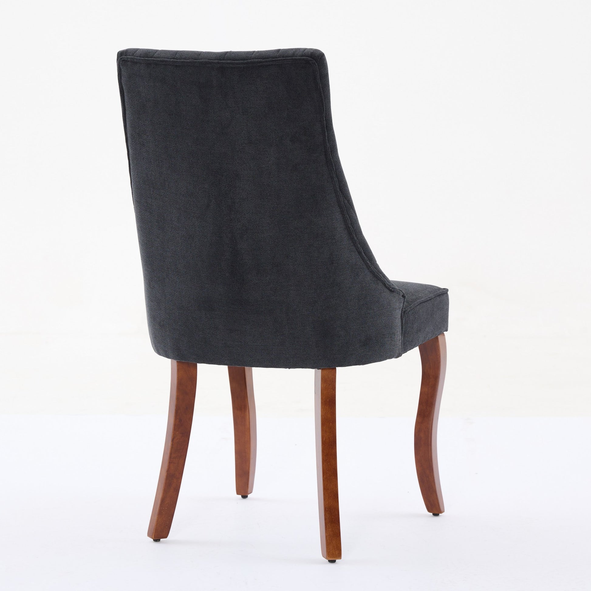 Dark grey upholstered dining chair with curved wooden legs