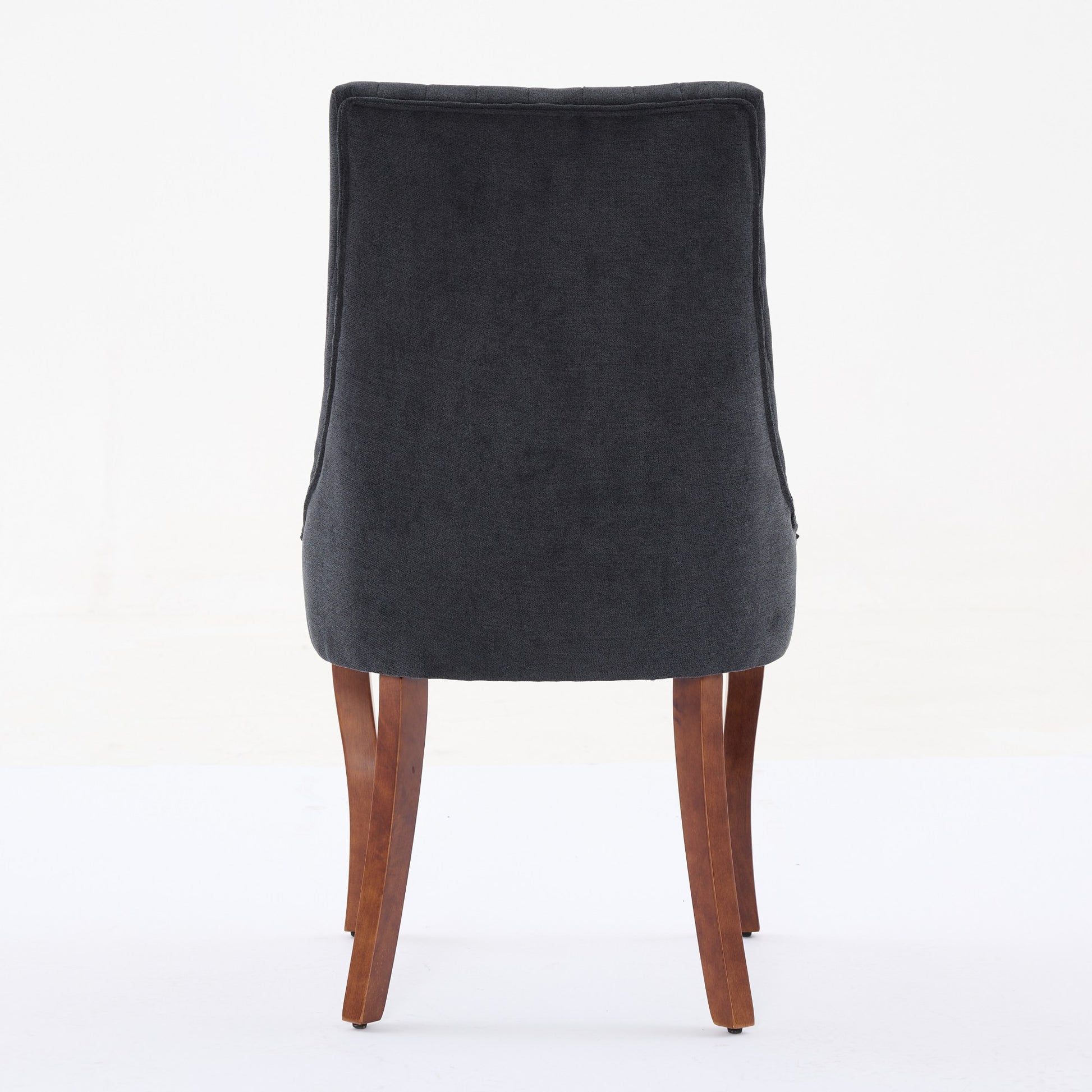 Dark grey fabric dining chair with tufted back and wooden legs