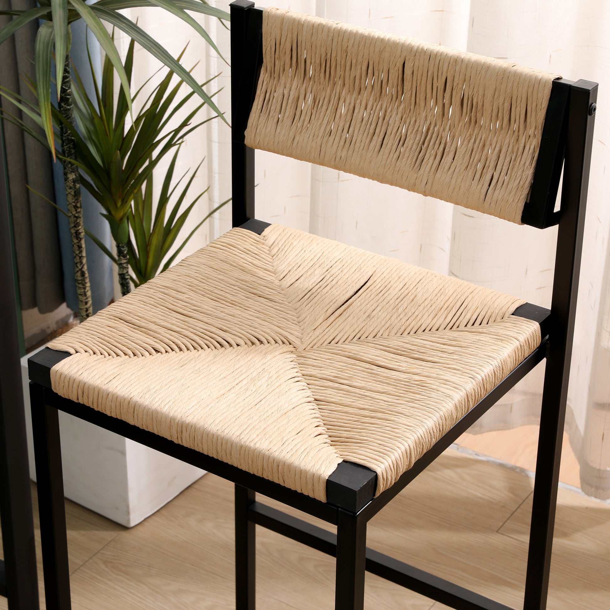 Black metal frame stool with woven natural rope seat and back