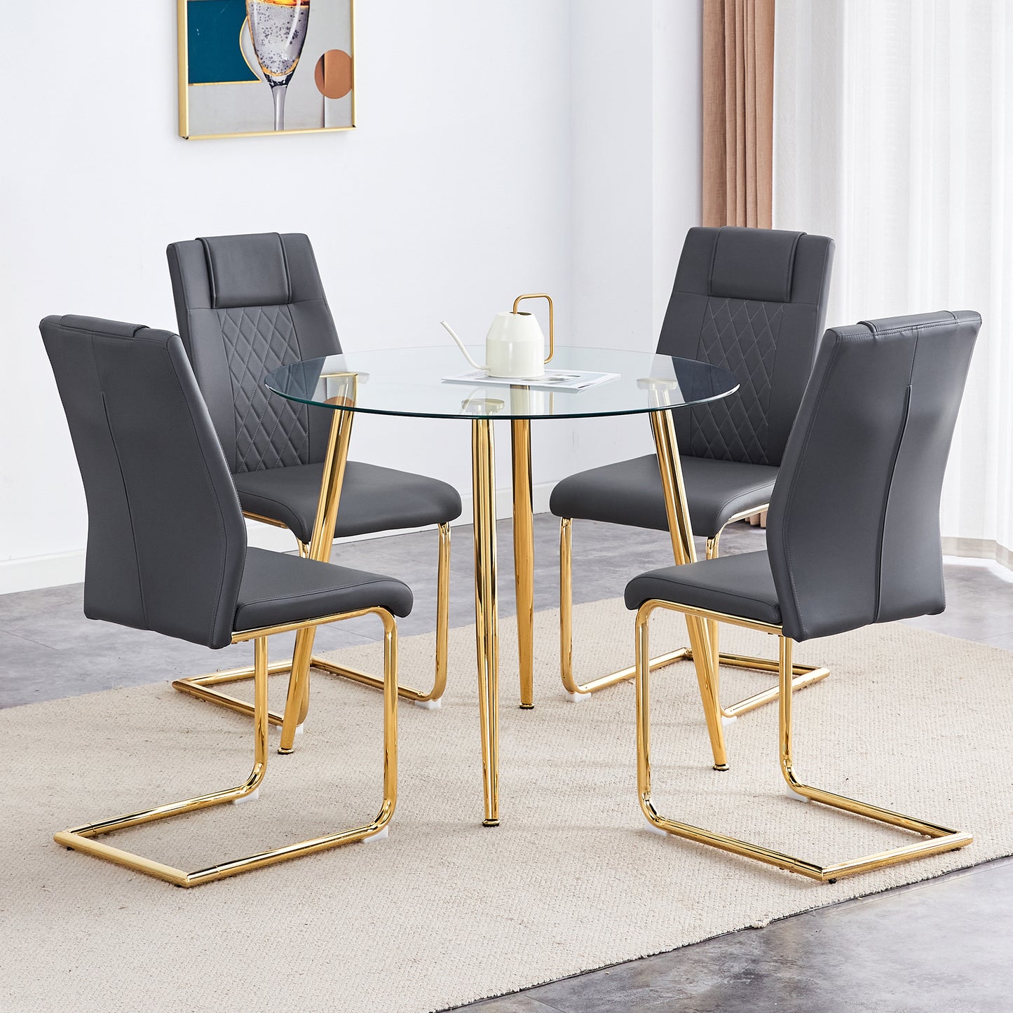 Four grey faux leather dining chairs with diamond stitching and gold legs around a glass table