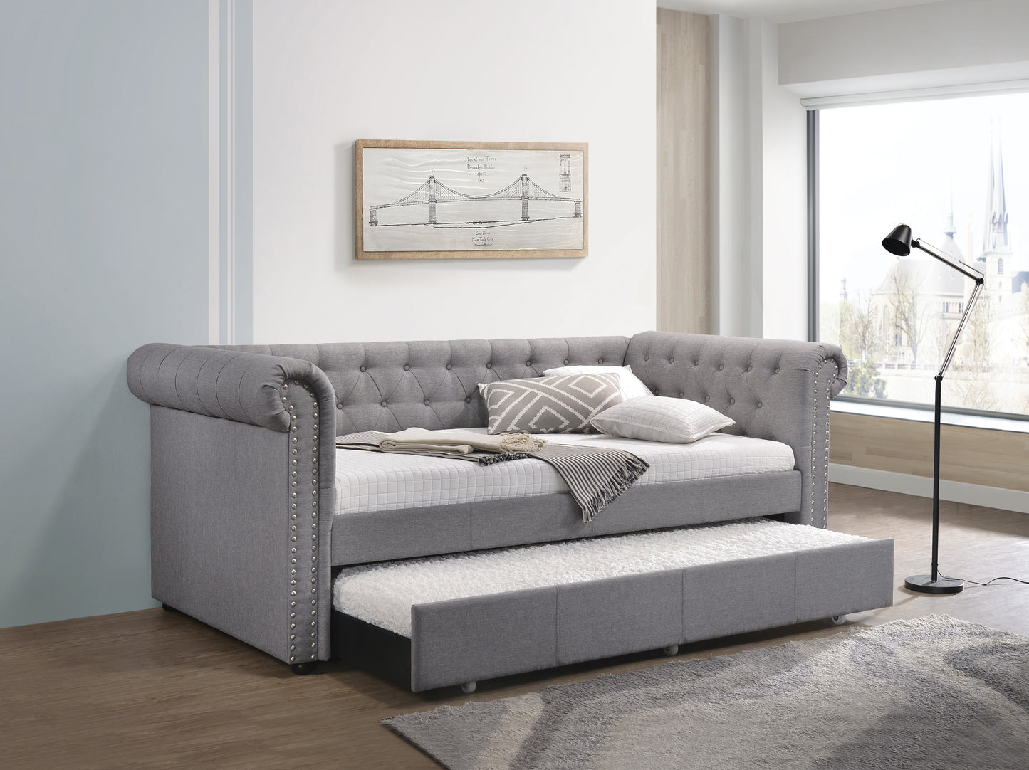Grey tufted daybed with pullout trundle silver nailhead trim and decorative pillows