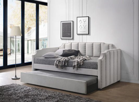 Velvet upholstered daybed in light gray with studded trim and pullout trundle perfect for guest rooms