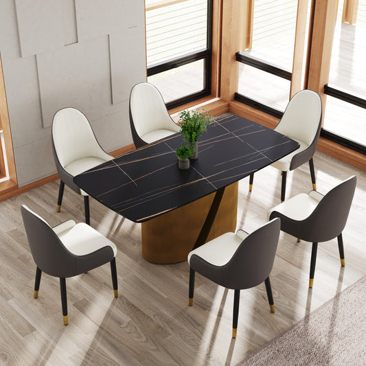 Modern black marble dining table with gold accents and whitegray chairs