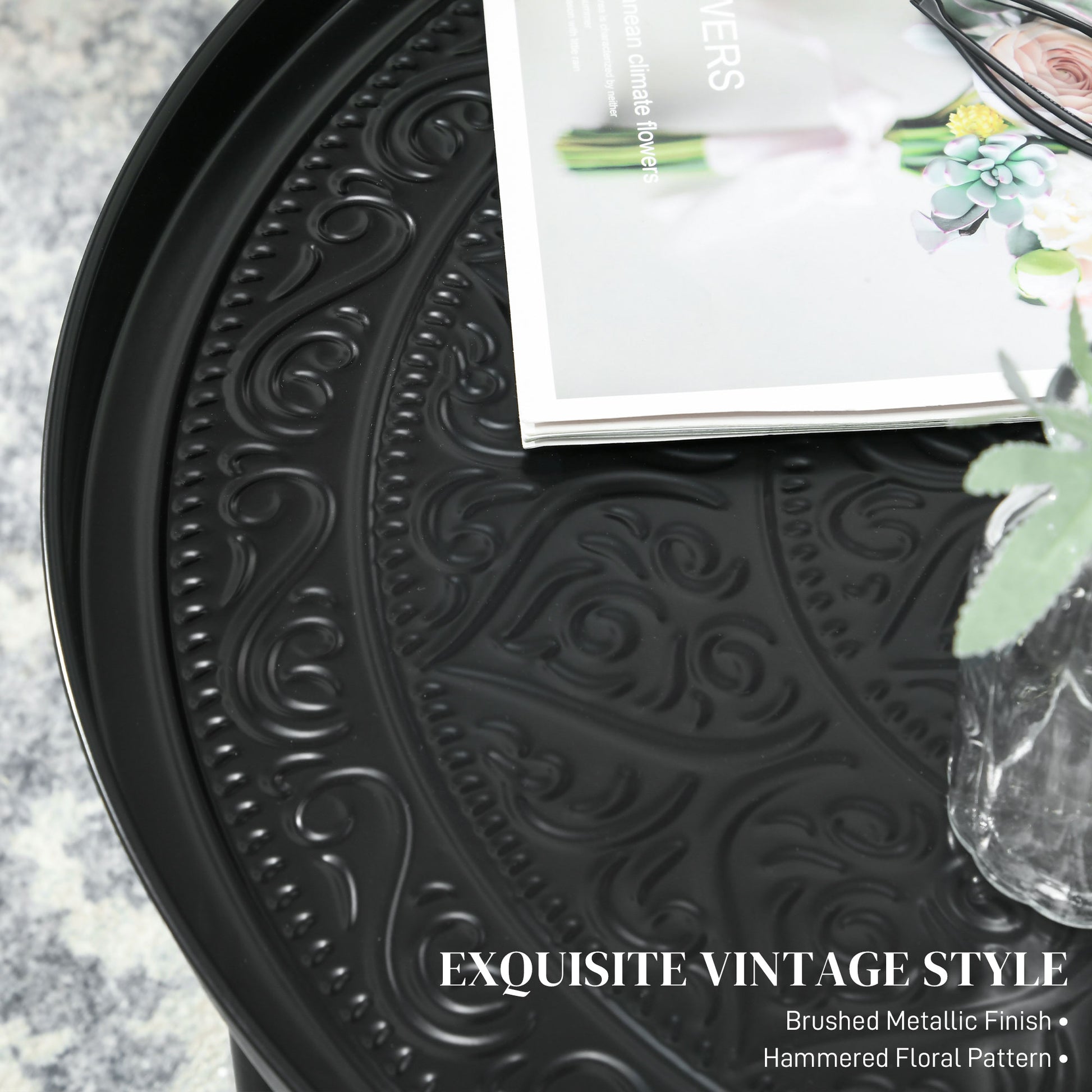 Black metal side table with embossed floral pattern