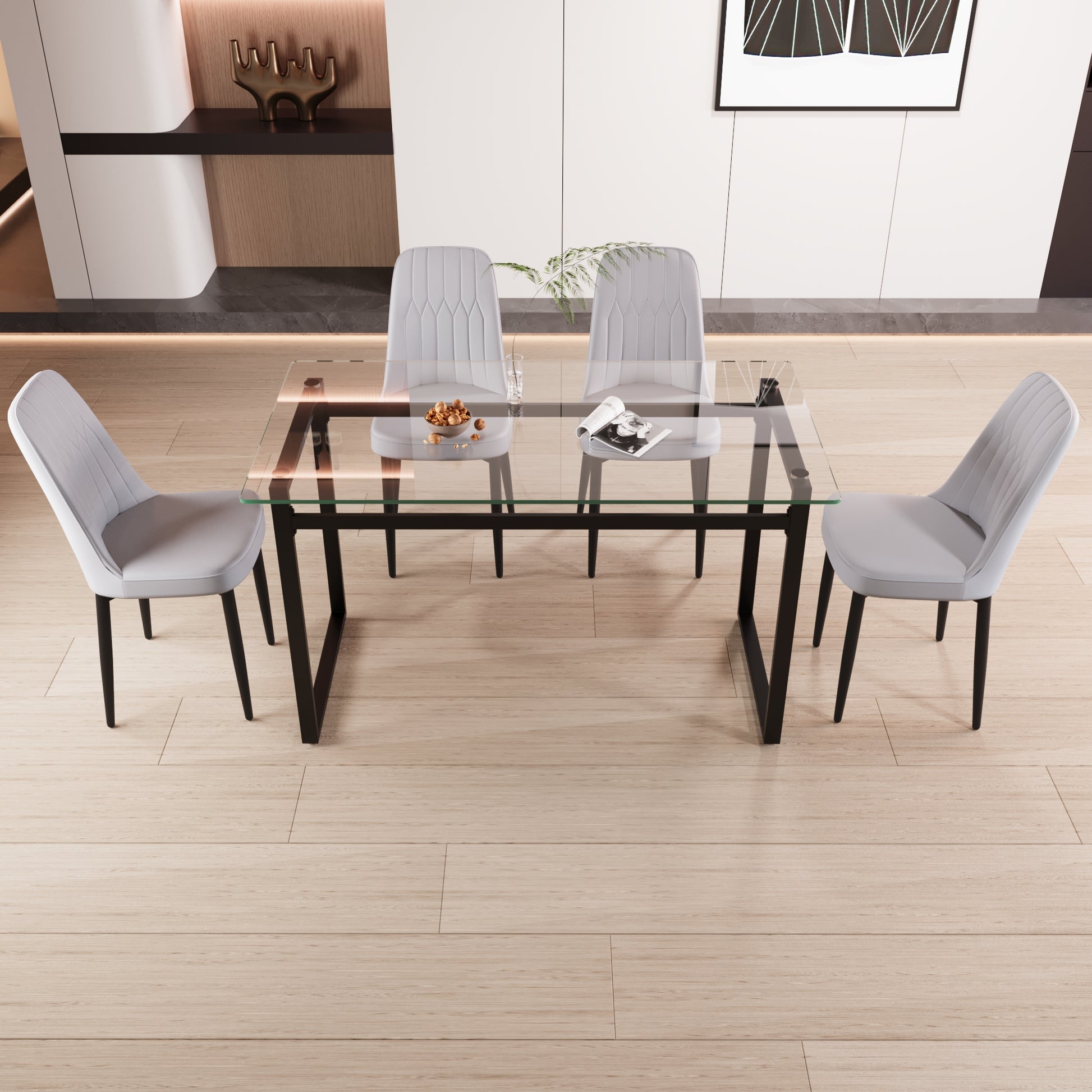 Modern grey upholstered dining chairs around a clear glass tabletop