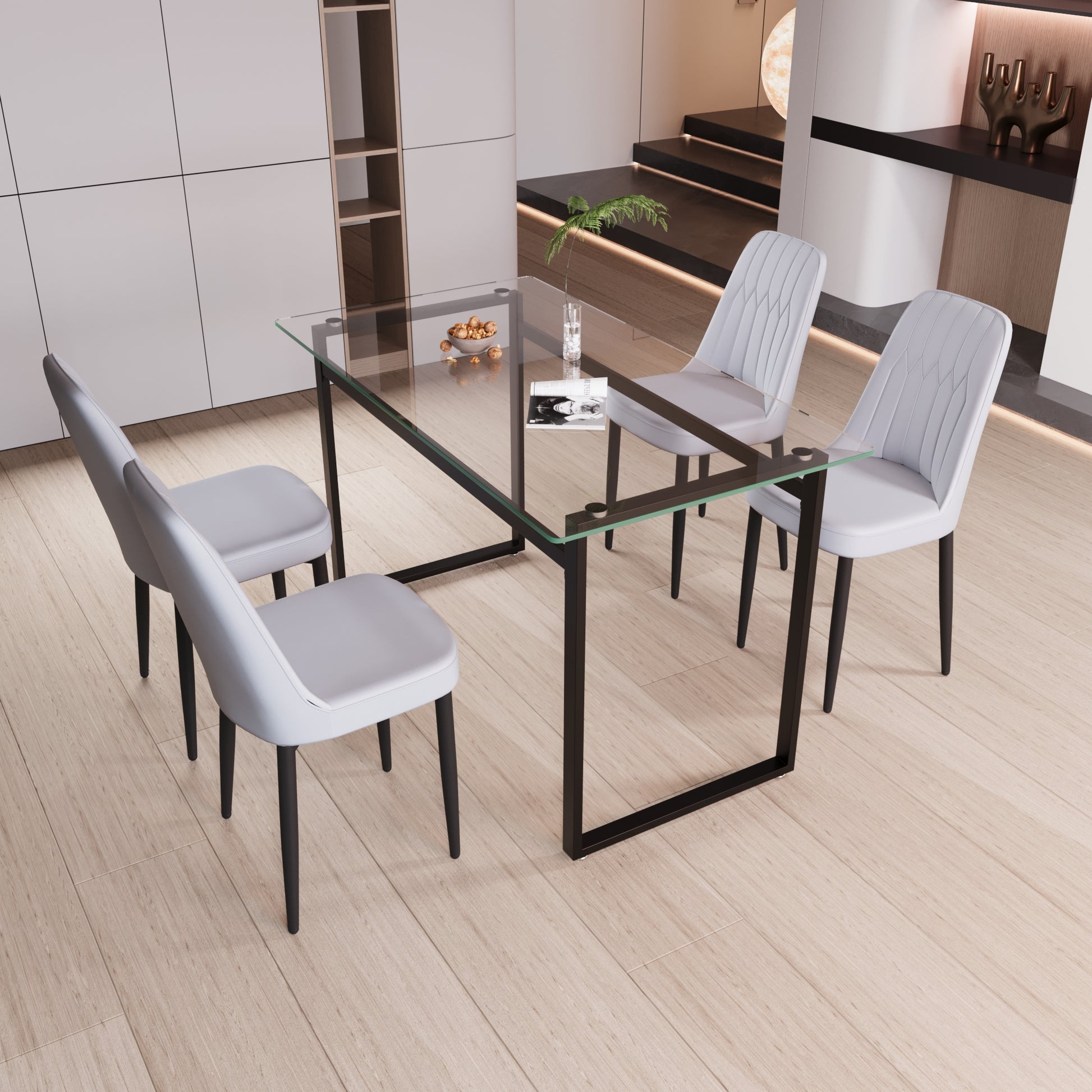 Modern glass dining table with black metal frame and four light gray chairs