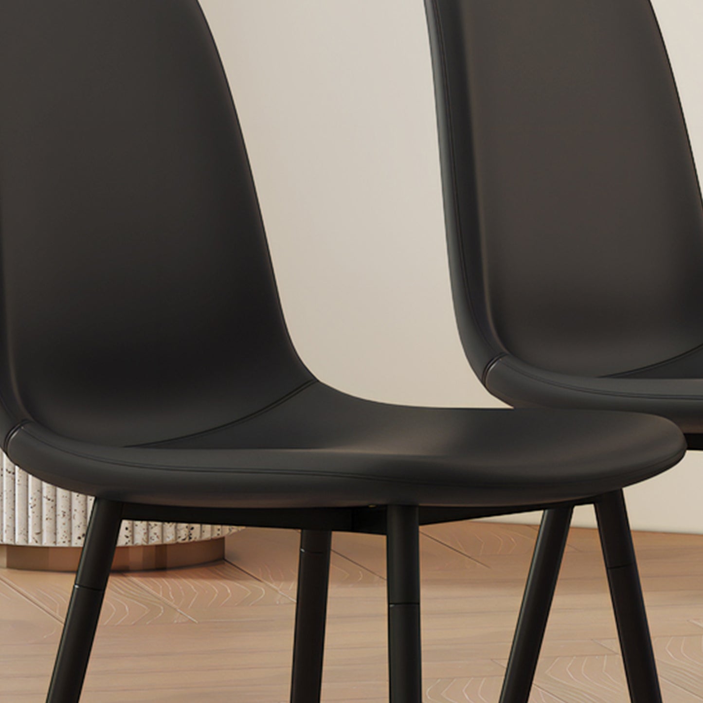 Sleek black faux leather dining chair with minimalist metal legs perfect for modern kitchens