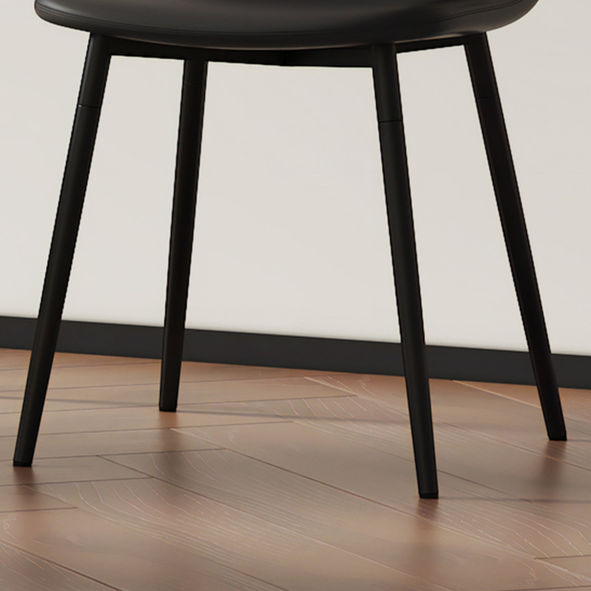 Black leather dining chair with slender matte black legs