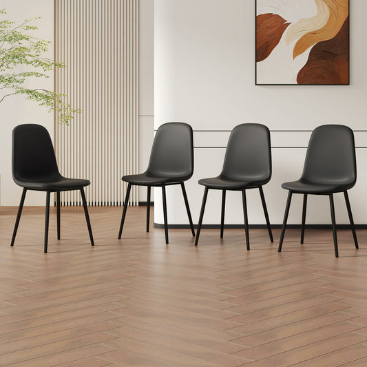 Four black modern dining chairs with thin metal legs on a wood floor
