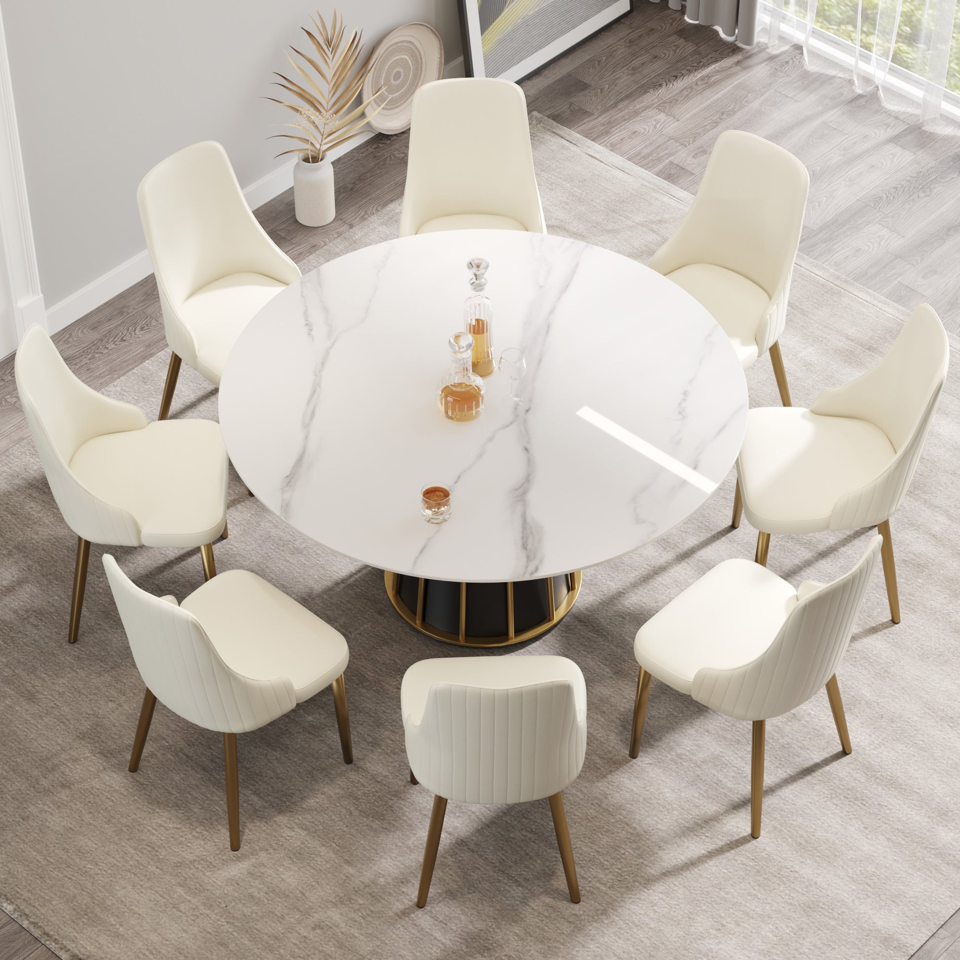 Cream velvet dining chairs with gold legs surrounding a marbletop dining table