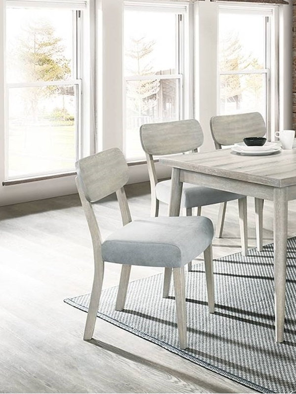 Light gray upholstered dining chair with distressed wood frame