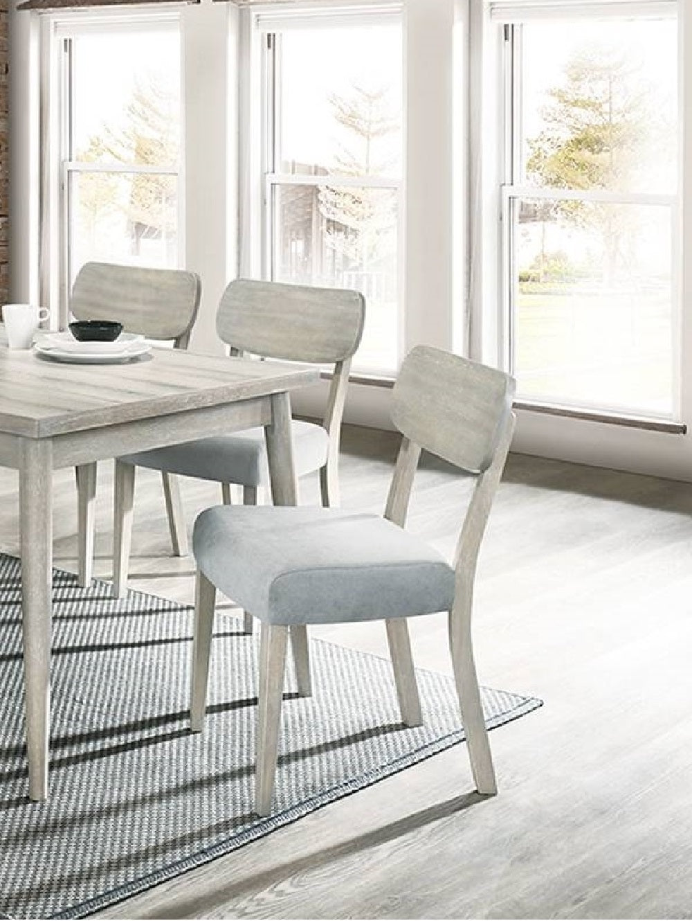 Light grey upholstered dining chair with wooden legs