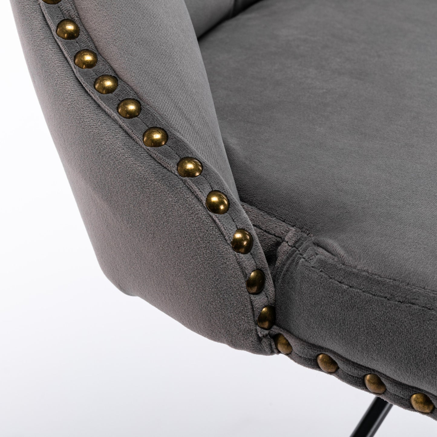 Dark grey velvet armchair with decorative brass nailhead trim