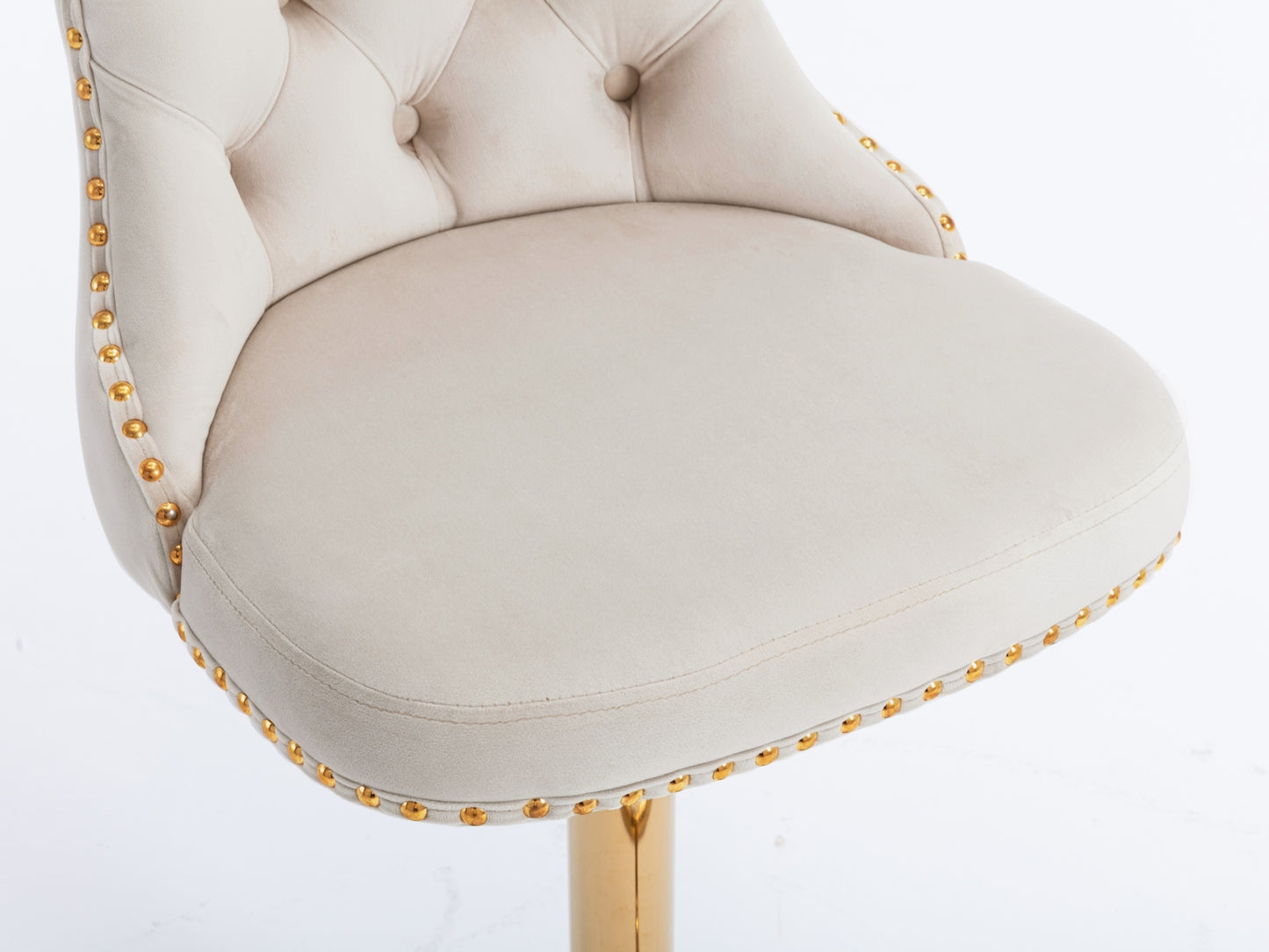 Cream velvet bar stool with gold nailhead trim and a polished gold base