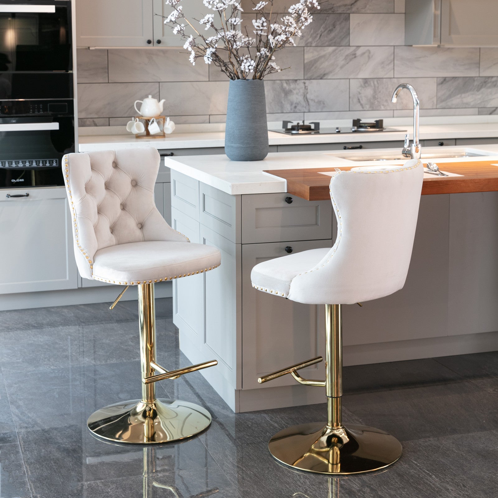 Tufted cream velvet bar stool with gold base and gold nailhead trim