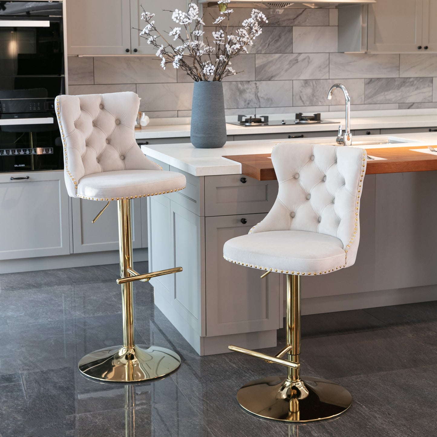 Tufted cream velvet bar stool with gold pedestal and accents