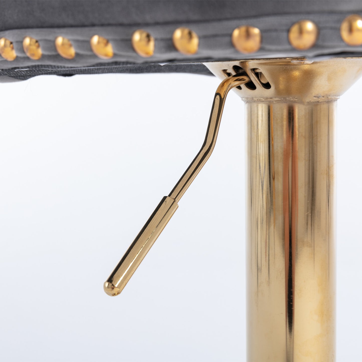 Adjustable bar stool lever with gold finish and decorative brass studs