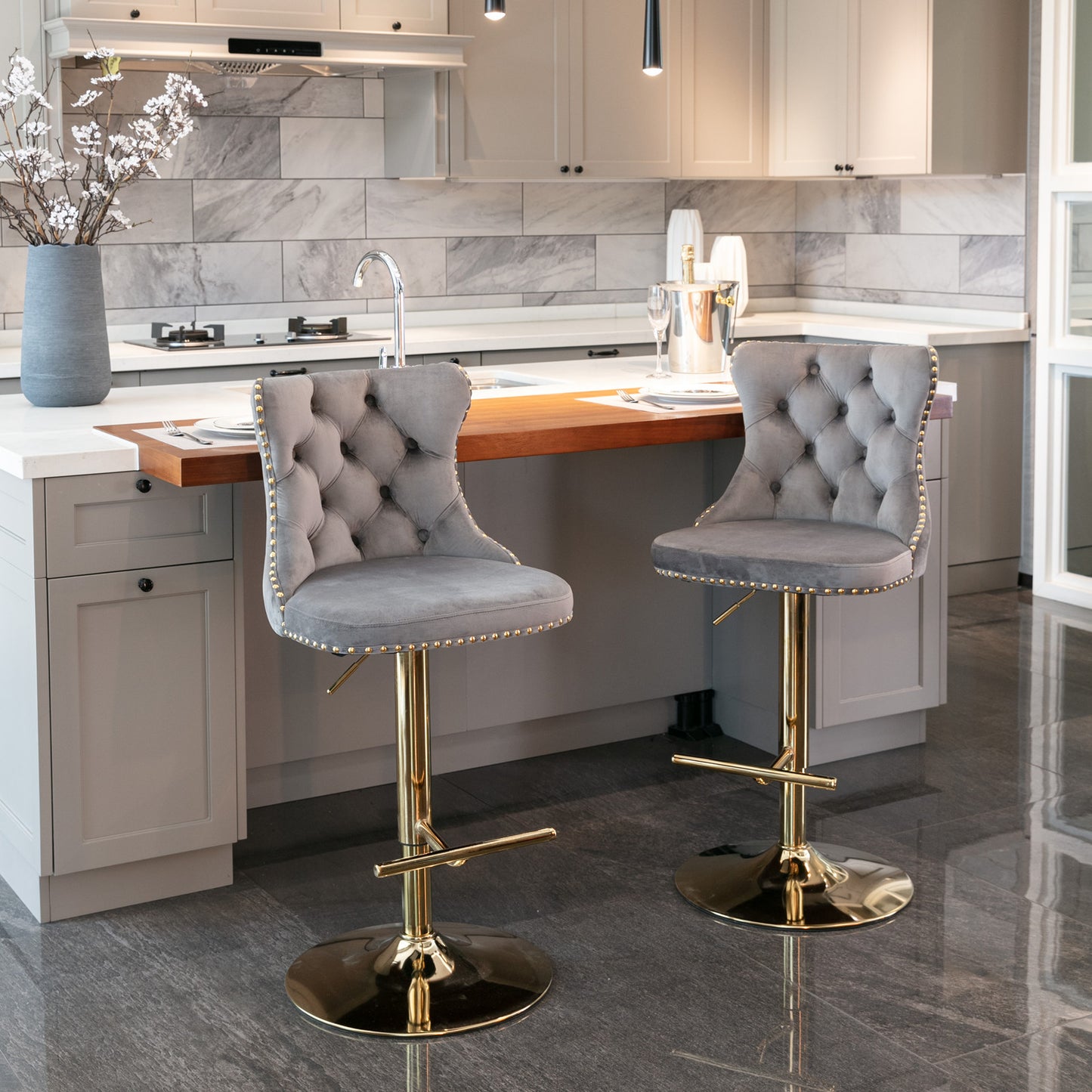 Tufted grey velvet bar stool with gold accents and adjustable height