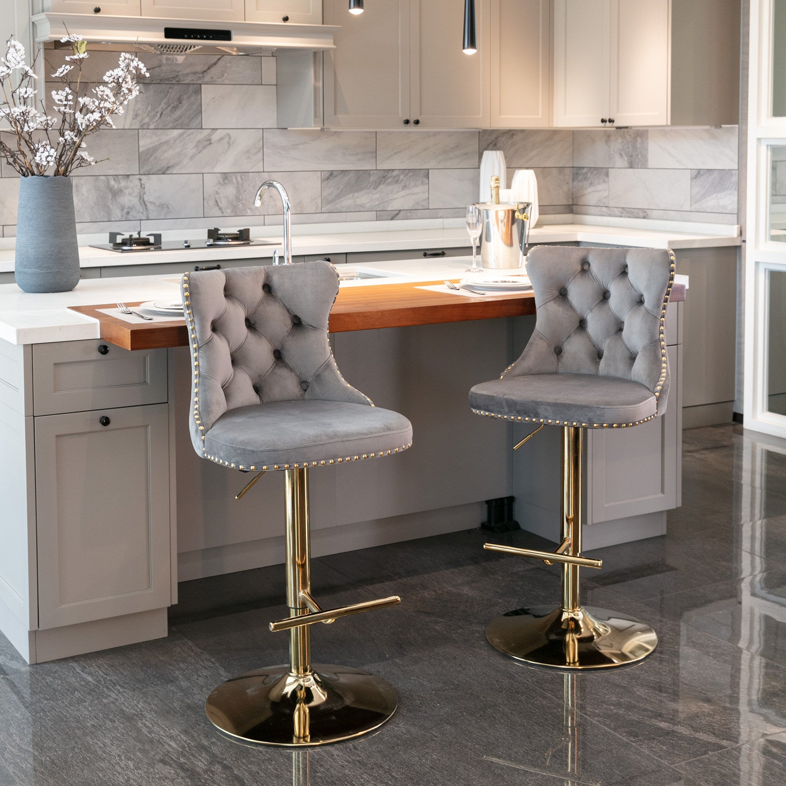 Tufted grey velvet bar stool with gold accents and adjustable height
