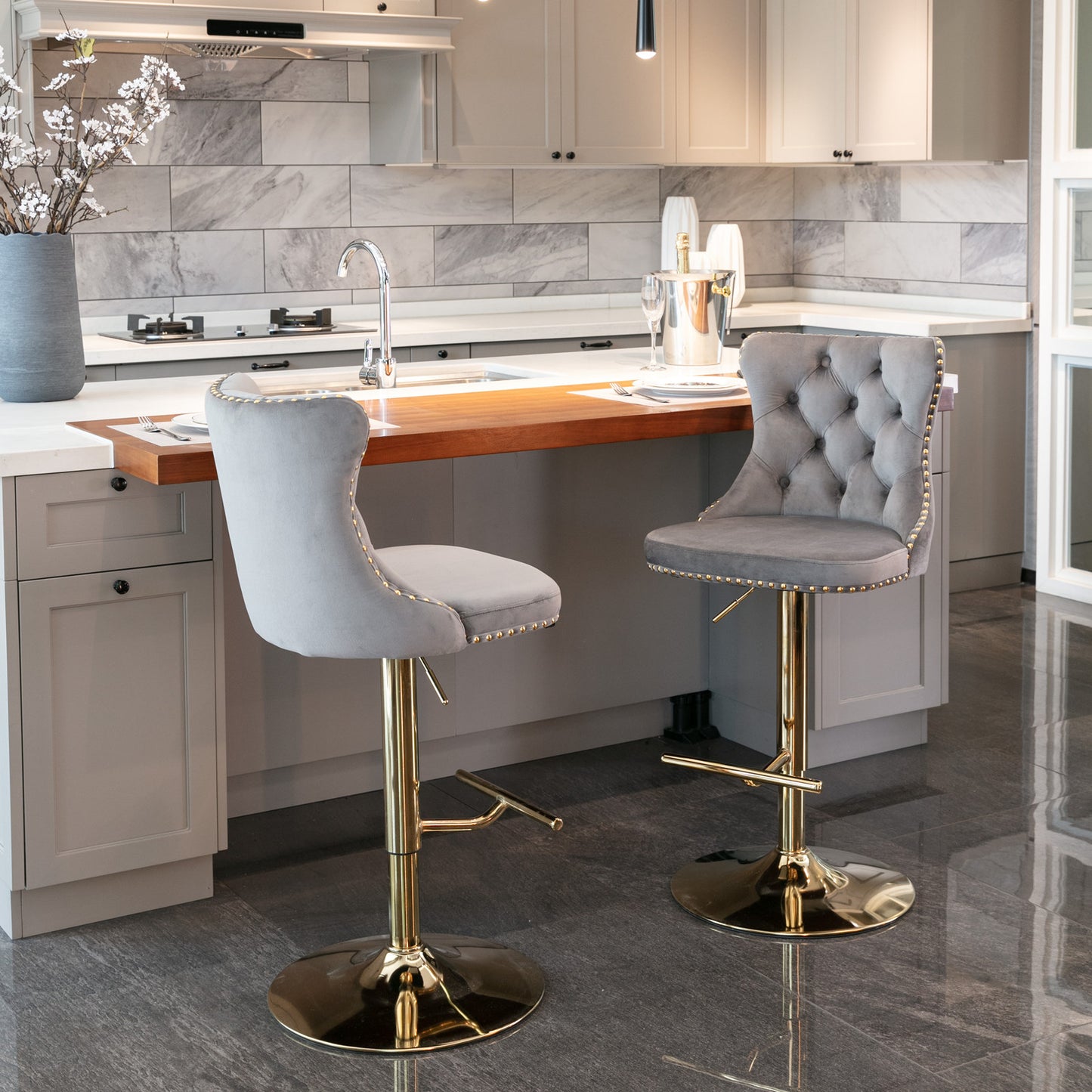 Grey velvet tufted bar stool with gold base and nailhead trim